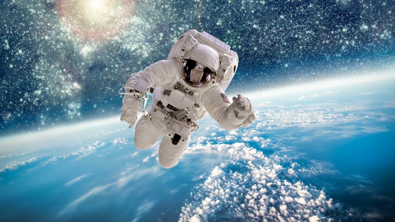 Космонавт в космосе на фоне земли