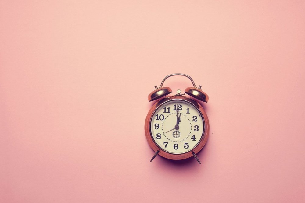 Часы на розовом фоне