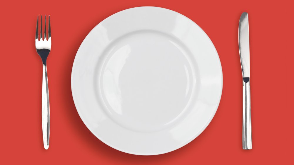 Пустая тарелка с вилкой и ножом