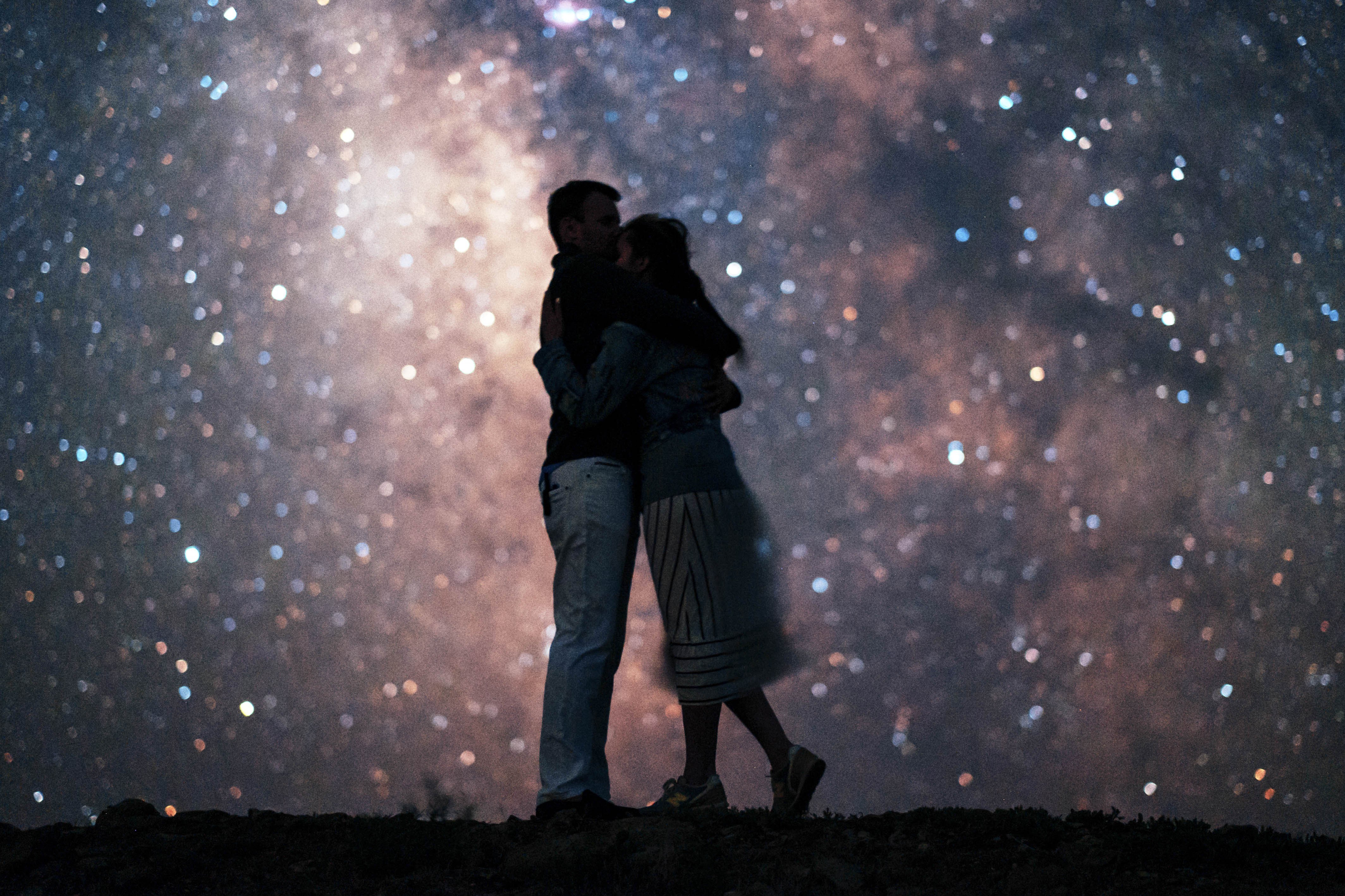 Мужчина ночью обнимает. Пара ночью. Влюбленные под звездами. Пара на фоне звездного неба. Фон влюбленные ночь.