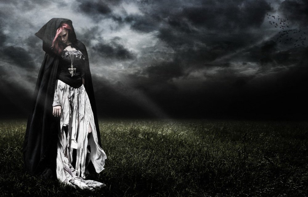 Девушка в чёрном плаще с капюшоном