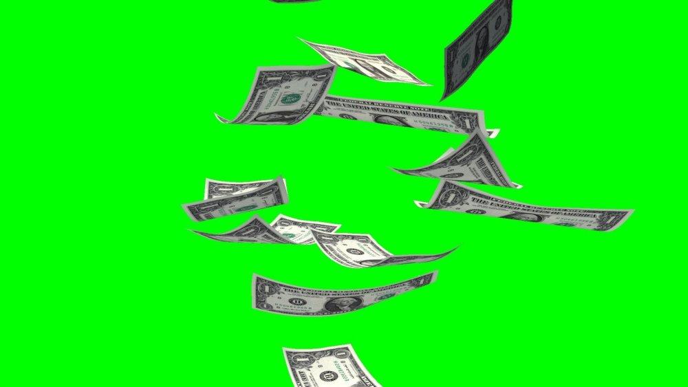 Падающие деньги на зеленом фоне