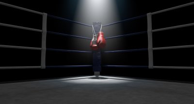 Боксерские перчатки на фоне ринга